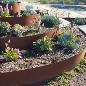 Degraus de jardim em aço Corten com muro de contenção e borda de paisagem